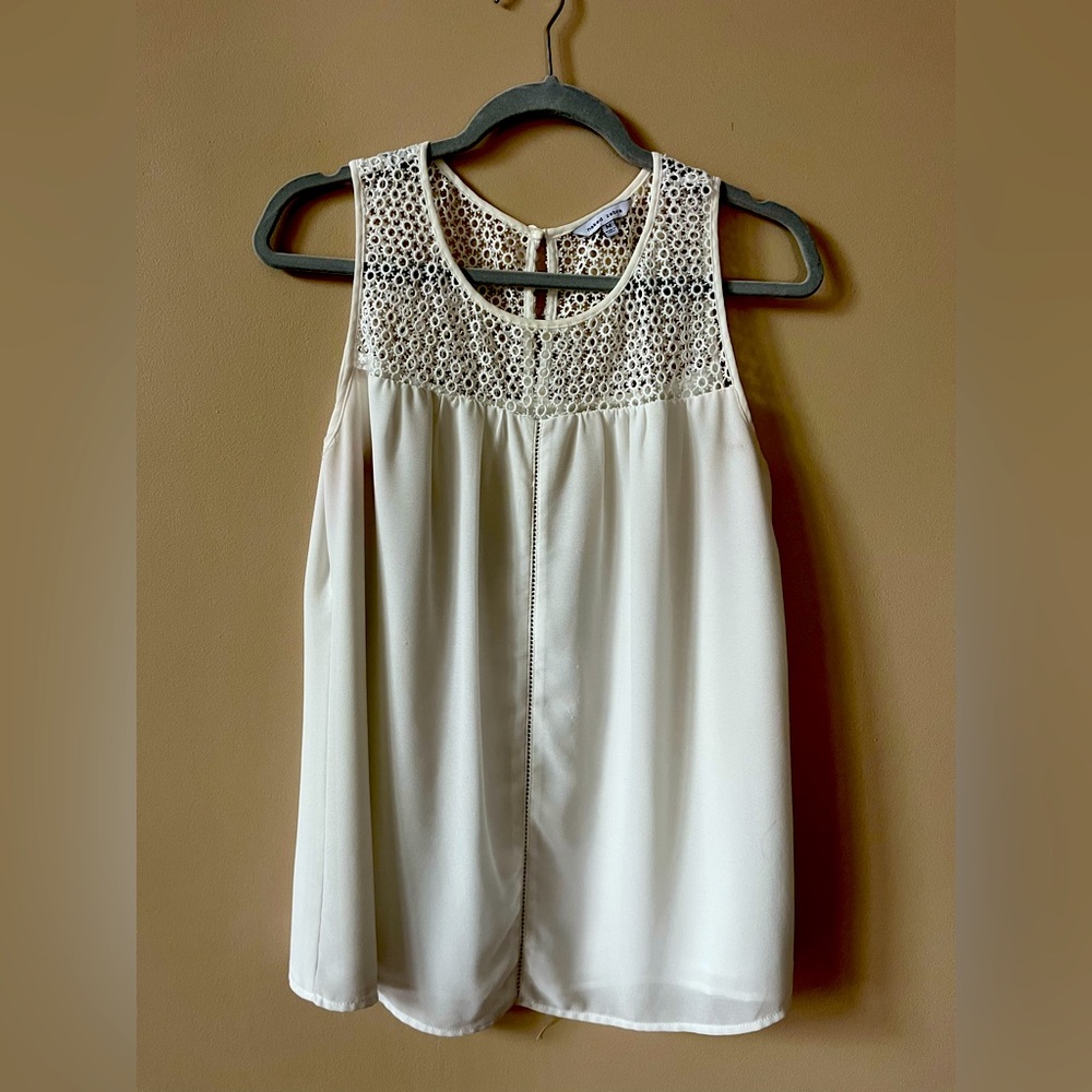 Off white dressy tank with white woven design around the neck and chest.